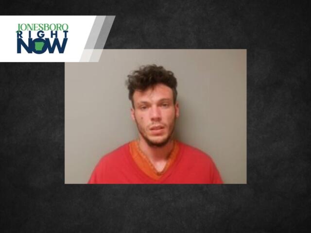 Mugshot-style photo of a young man wearing a red shirt against a gray wall, with a Jonesboro Right Now news banner in the corner.