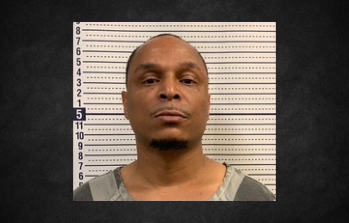 Mugshot of a man facing the camera in front of a height-measurement wall.