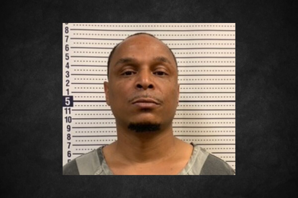 Mugshot of a man facing the camera in front of a height-measurement wall.