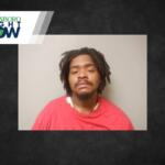 Mugshot-style photo of a man with dreadlocks wearing a red shirt, neutral background, Jonesboro Light Now logo in the top-left corner.