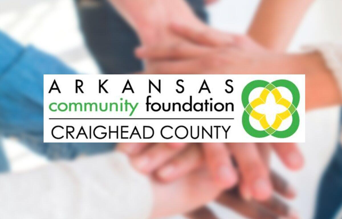 Arkansas Community Foundation Craighead County logo with hands stacked in a circle in the blurred background behind it.