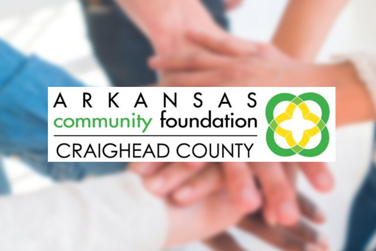 Arkansas Community Foundation Craighead County logo with hands stacked in a circle in the blurred background behind it.