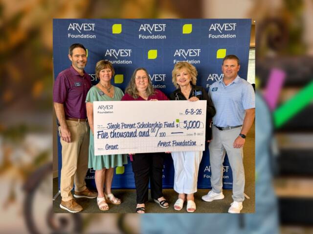 Five adults pose with an oversized ARVEST Foundation check for $5,000 to the Single Parent Scholarship Fund, in front of a branded backdrop.