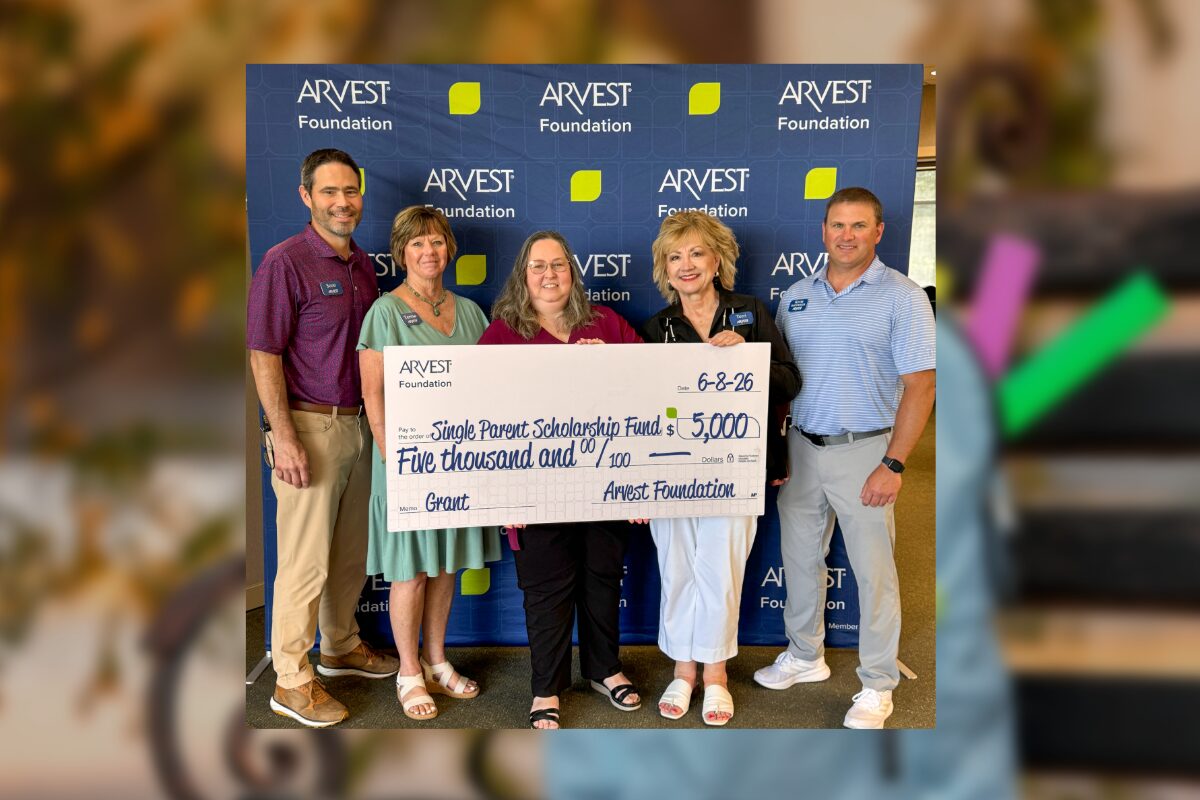 Five adults pose with an oversized ARVEST Foundation check for $5,000 to the Single Parent Scholarship Fund, in front of a branded backdrop.