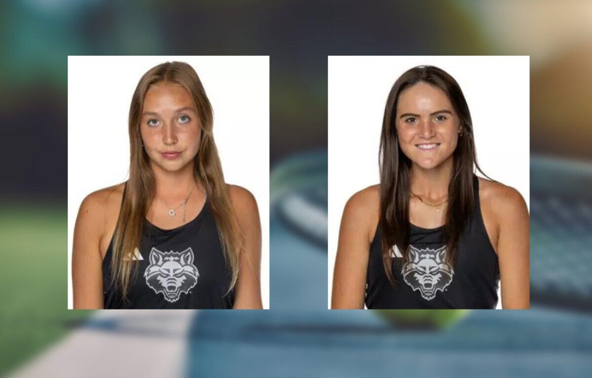Two young women in black tank tops with a wolf logo, white background; left: light brown hair, neutral expression, right: dark brown hair, smiling.