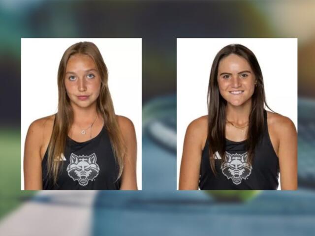 Two young women in black tank tops with a wolf logo, white background; left: light brown hair, neutral expression, right: dark brown hair, smiling.
