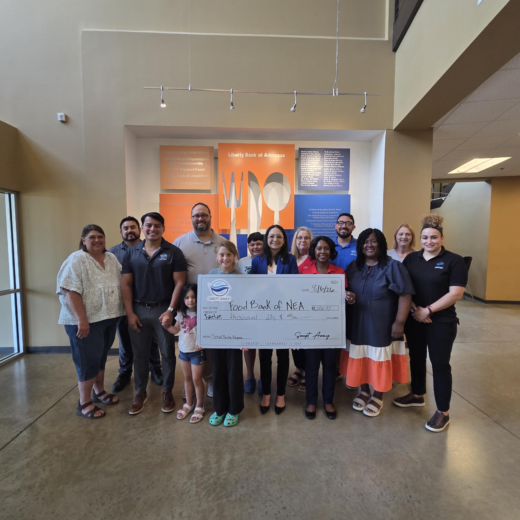 Swept Away Janitorial presents check to Food Bank of NEA