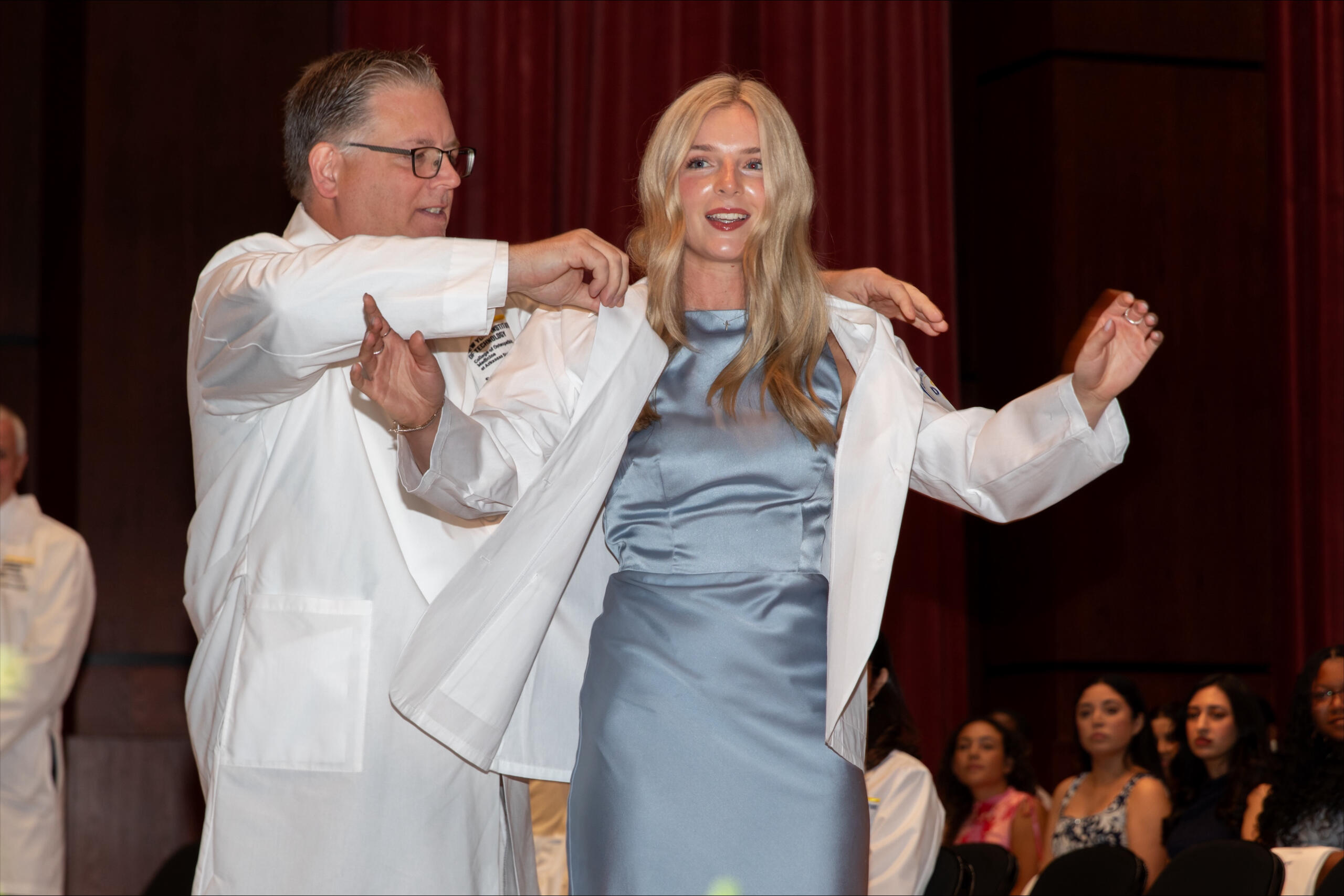 Allison Shinabery, a Jonesboro native and incoming first-year medical student at NYIT College of Osteopathic Medicine at Arkansas State University, is coated by Dr. Steven Lewis, NYITCOM at A-State's associate dean of academic affairs.